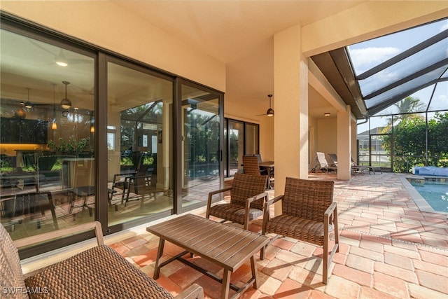 view of patio / terrace featuring glass enclosure and an outdoor pool