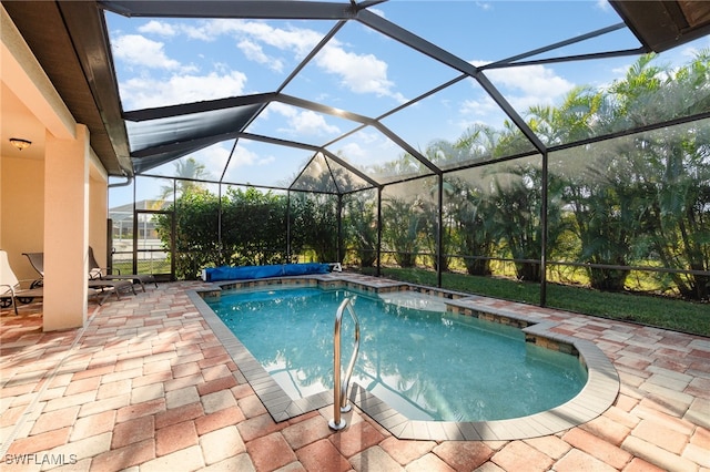 outdoor pool featuring a patio area and glass enclosure