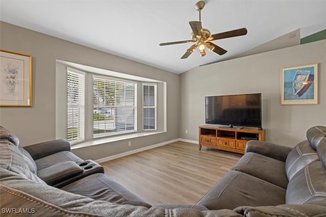 living room featuring light hardwood / wood-style flooring, lofted ceiling, and ceiling fan