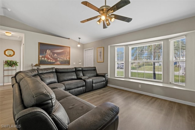 living room with light hardwood / wood-style floors, lofted ceiling, and ceiling fan