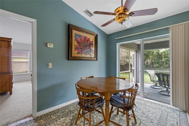 dining area featuring lofted ceiling, carpet, and ceiling fan