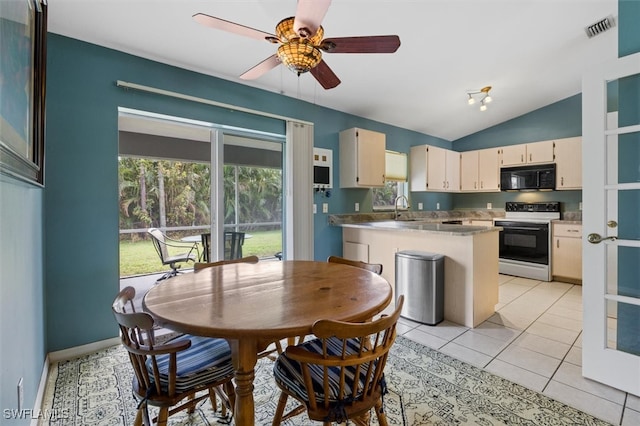 kitchen with lofted ceiling, cream cabinets, white range with electric cooktop, light tile patterned floors, and ceiling fan