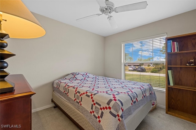 bedroom featuring light carpet and ceiling fan