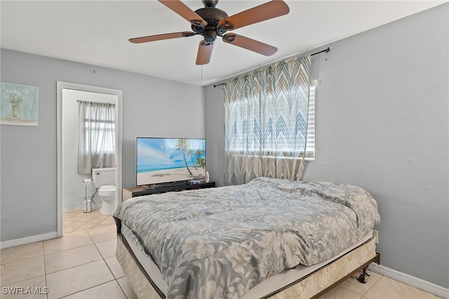 tiled bedroom featuring ceiling fan and ensuite bath