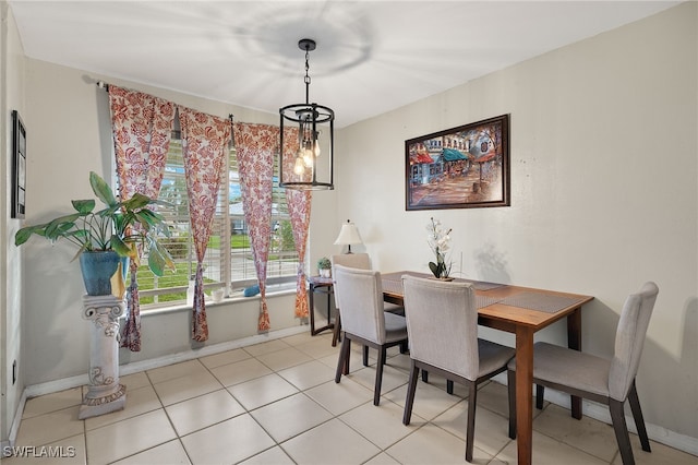 dining space with light tile patterned flooring and a notable chandelier