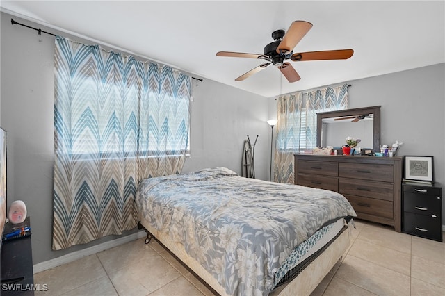 tiled bedroom featuring ceiling fan