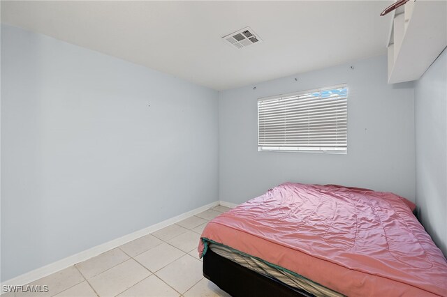 bedroom featuring light tile patterned flooring