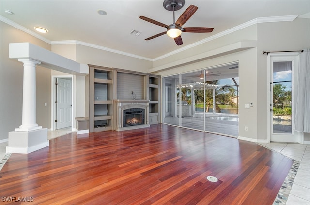 unfurnished living room with decorative columns, ceiling fan, ornamental molding, and hardwood / wood-style floors