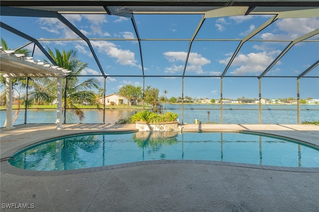 view of swimming pool featuring a patio area, a water view, and glass enclosure