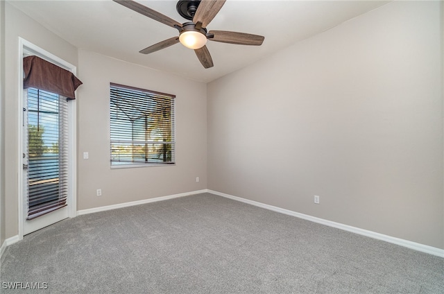 carpeted spare room with ceiling fan