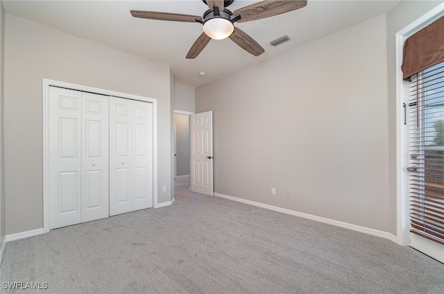 unfurnished bedroom featuring a closet, ceiling fan, and light carpet