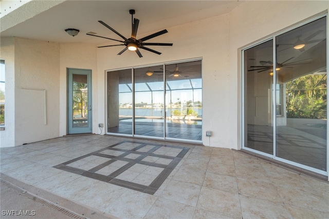 view of patio featuring a water view and ceiling fan