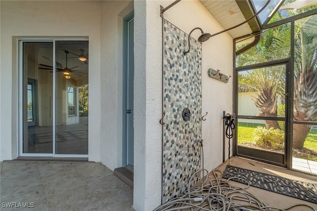 exterior space featuring ceiling fan