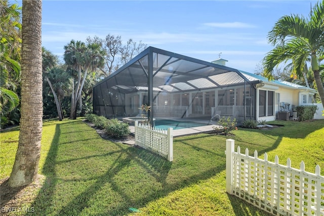 view of yard with central AC, a patio, and glass enclosure