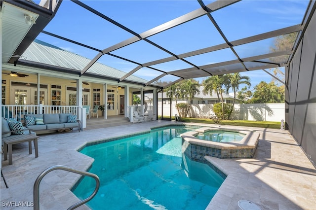 view of swimming pool featuring an outdoor living space, ceiling fan, an in ground hot tub, and glass enclosure