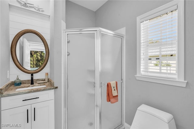 bathroom with vanity, toilet, and an enclosed shower