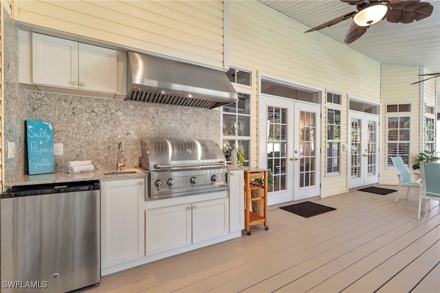 wooden deck featuring area for grilling, sink, french doors, ceiling fan, and a grill