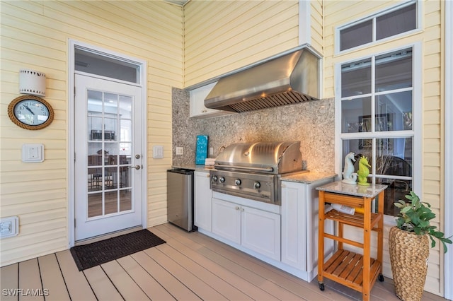 wooden deck featuring an outdoor kitchen and area for grilling