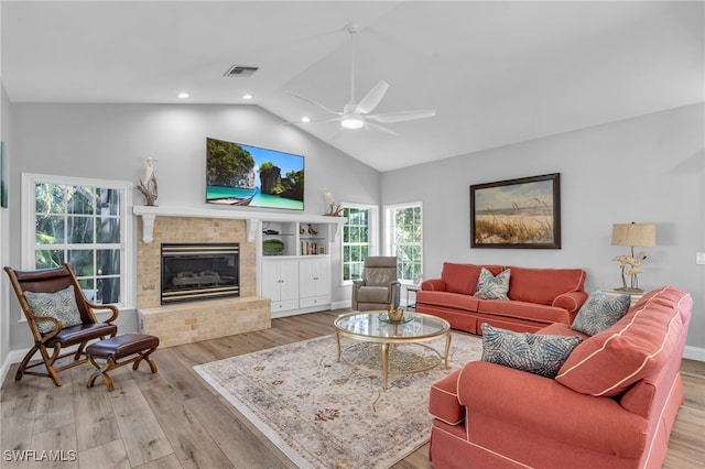 living room featuring vaulted ceiling, light hardwood / wood-style floors, and ceiling fan