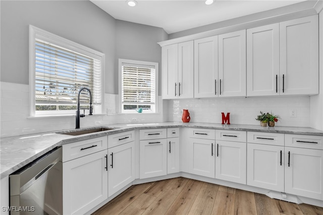 kitchen with white cabinetry, light wood-type flooring, sink, and plenty of natural light