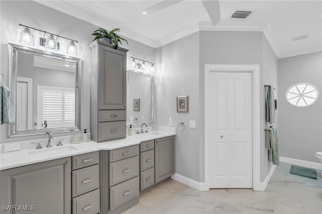 bathroom featuring vanity, crown molding, and toilet