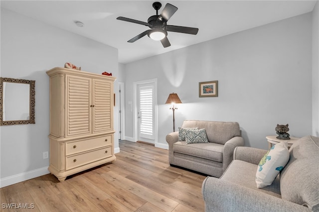 living area with ceiling fan and light hardwood / wood-style flooring