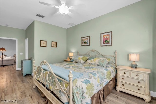 bedroom with light wood-type flooring and ceiling fan