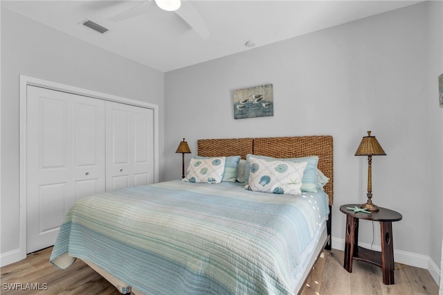 bedroom with a closet, ceiling fan, and light hardwood / wood-style flooring