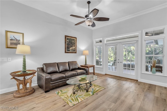 living room featuring ornamental molding, french doors, light hardwood / wood-style floors, and ceiling fan