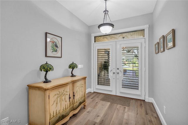 entryway with french doors and light hardwood / wood-style floors