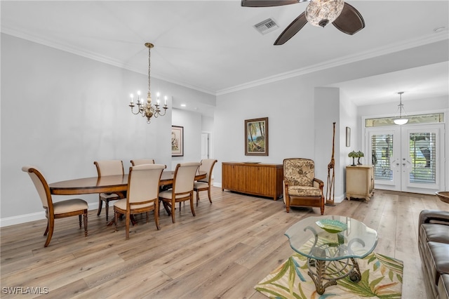 dining room featuring french doors, ornamental molding, light hardwood / wood-style flooring, and ceiling fan with notable chandelier