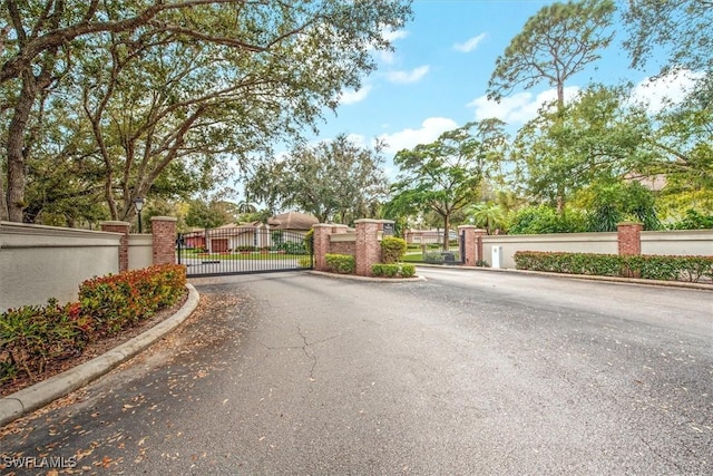 15600 Willow Oak Ct, Fort Myers, FL 33912 - view of asphalt street with a gate, curbs, and a gated entry