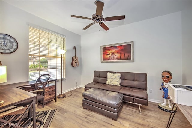 living room featuring ceiling fan and light wood-type flooring