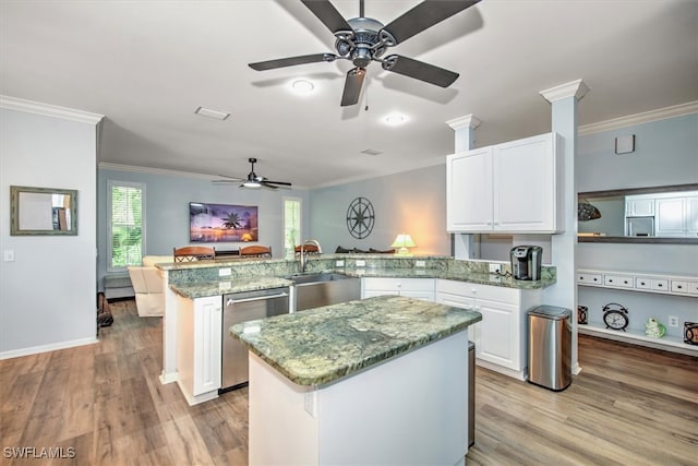 kitchen featuring stainless steel dishwasher, a kitchen island, kitchen peninsula, and light wood-type flooring