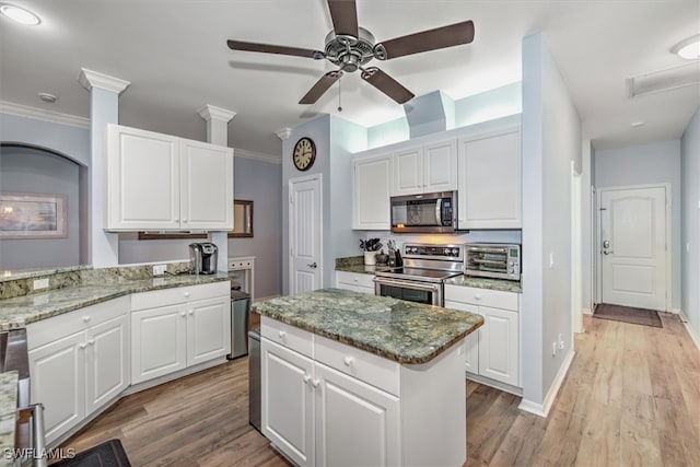 kitchen featuring light hardwood / wood-style flooring, white cabinets, and stainless steel appliances