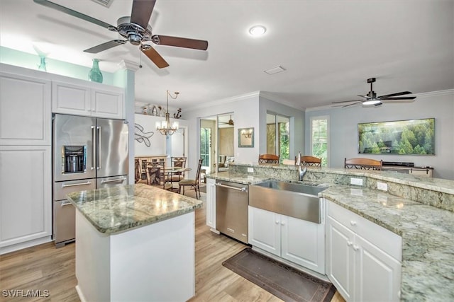 15600 Willow Oak Ct, Fort Myers, FL 33912 - kitchen featuring stainless steel appliances, a ceiling fan, a sink, light wood-type flooring, and crown molding
