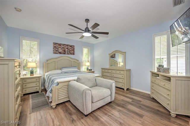 15600 Willow Oak Ct, Fort Myers, FL 33912 - bedroom with light wood-type flooring, multiple windows, ceiling fan, and baseboards