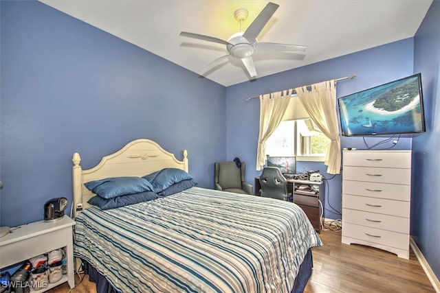 bedroom with ceiling fan and wood-type flooring