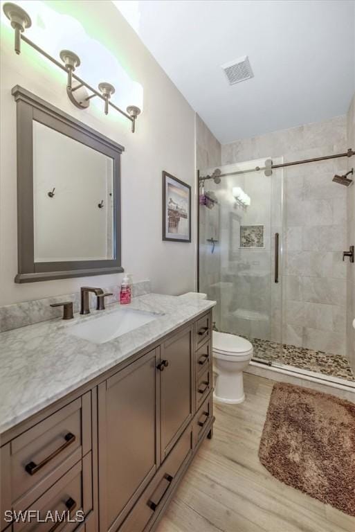 15600 Willow Oak Ct, Fort Myers, FL 33912 - full bathroom featuring wood finished floors, toilet, a shower stall, and vanity