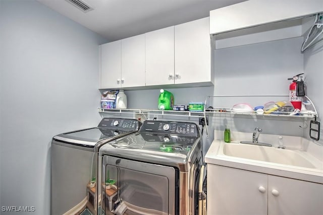 15600 Willow Oak Ct, Fort Myers, FL 33912 - laundry room featuring washing machine and dryer and cabinet space