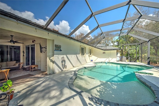 view of swimming pool with a lanai, a patio, and ceiling fan