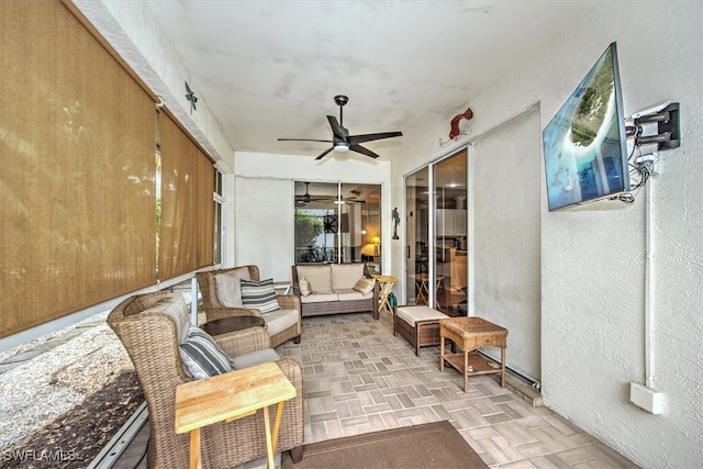 sunroom featuring ceiling fan