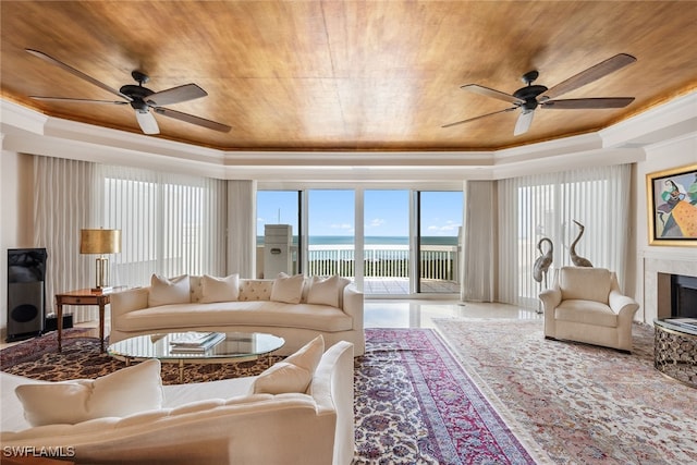 living room with ornamental molding, a water view, ceiling fan, and wooden ceiling