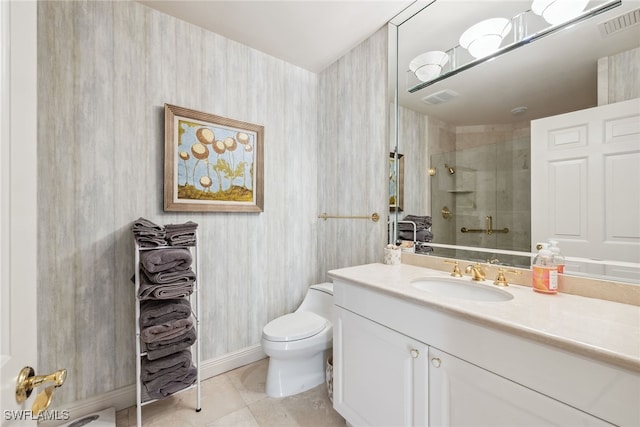 bathroom featuring a tile shower, vanity, toilet, and tile patterned floors