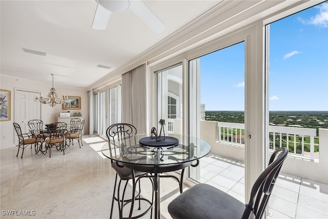 dining area with ceiling fan with notable chandelier and crown molding