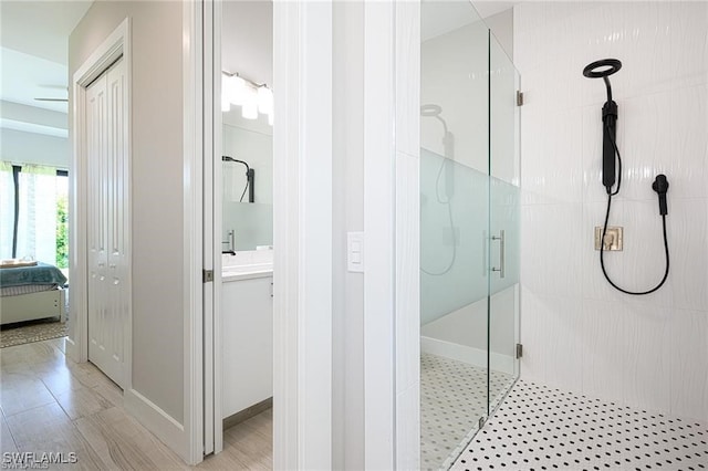 bathroom featuring vanity, an enclosed shower, and hardwood / wood-style flooring