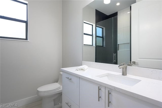 bathroom featuring toilet and vanity