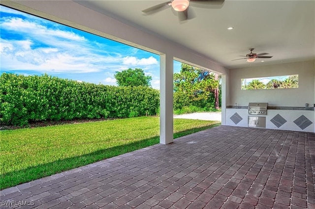 view of patio with ceiling fan, grilling area, and exterior kitchen