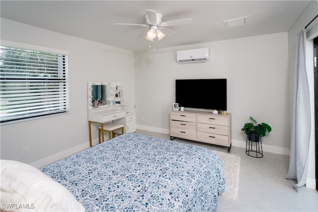 bedroom with a wall mounted air conditioner, light tile patterned floors, and ceiling fan