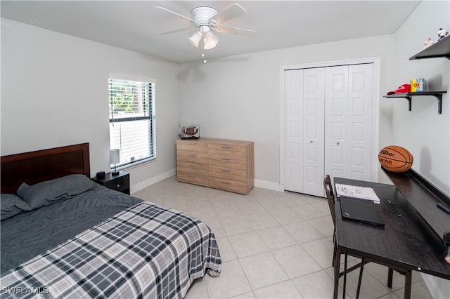 bedroom with a closet, ceiling fan, and light tile patterned floors